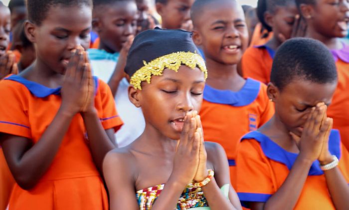 A group of kids praying
